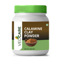 Jar of Vedcare Calamine Clay Powder with green lid on a white background