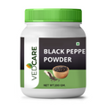 Vedcare Black Pepper Powder jar with green lid on a white background