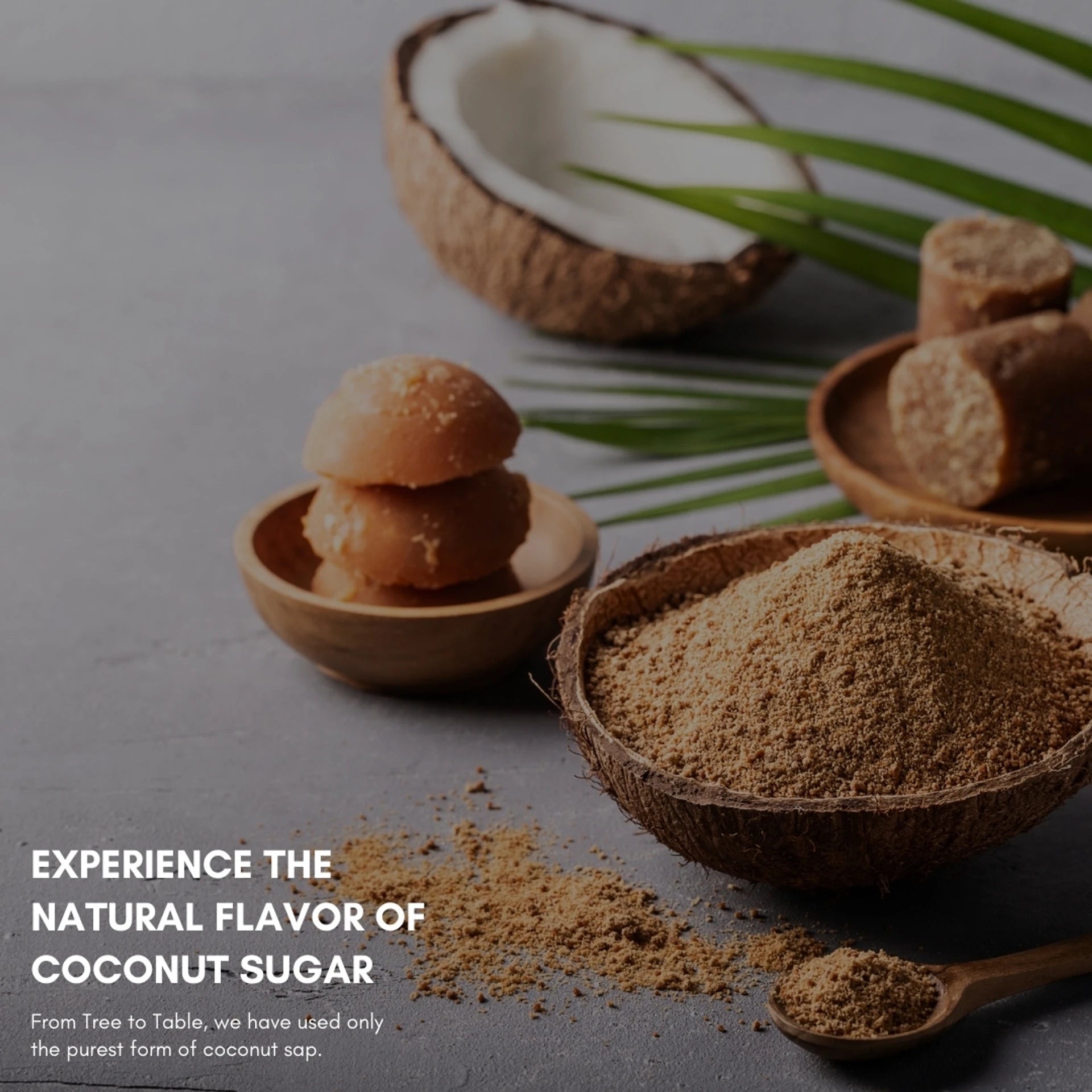 Coconut sugar in a wooden bowl with a coconut and cookies on a gray background.