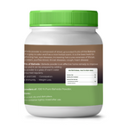 Container of Baheda powder with green lid and label on a white background