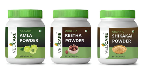 Three jars of Vedcare organic powders on a white background