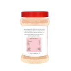 Container of pink rock salt with a red lid on a white background